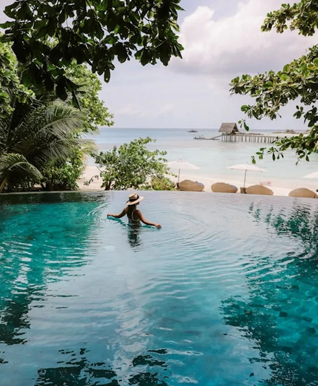 An island resort pool at the water line